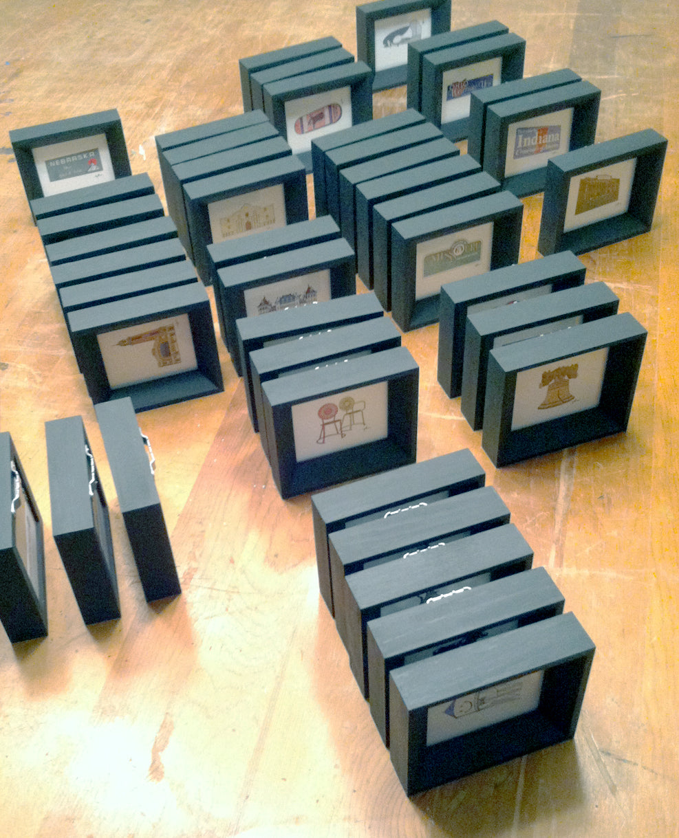 small framed state icon art prints by united goods lined up like dominoes